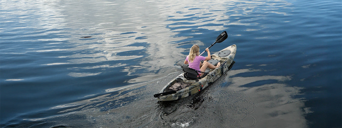 single female paddler on the water